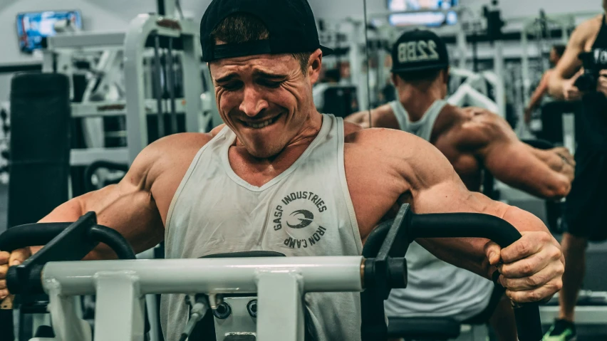 a man in a gym doing exercises on the machine