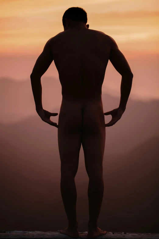 a man that is standing up in the sunset