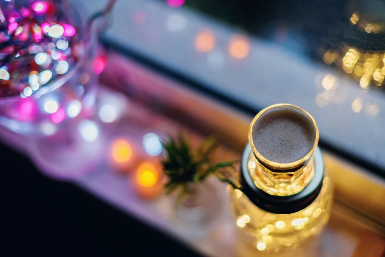 coffee in a tall glass sitting on a table near a window