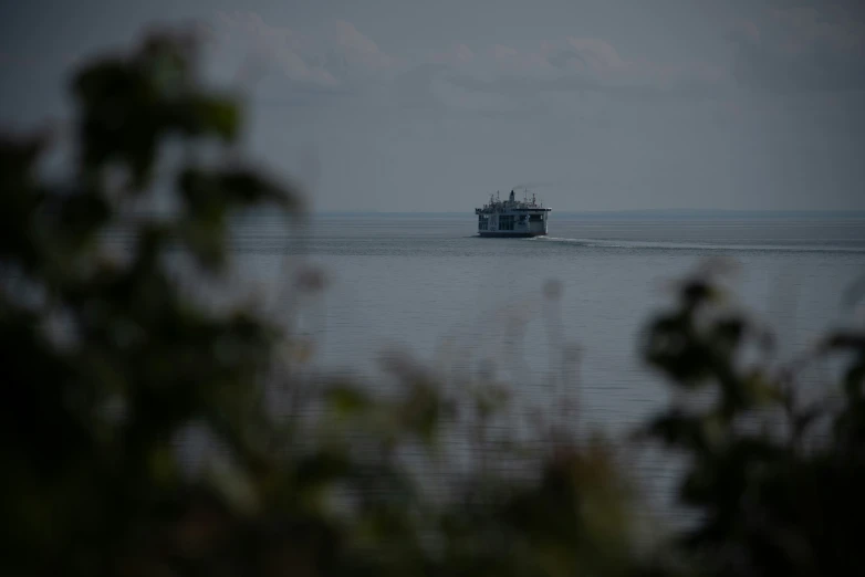 a boat sails across the ocean as people look on