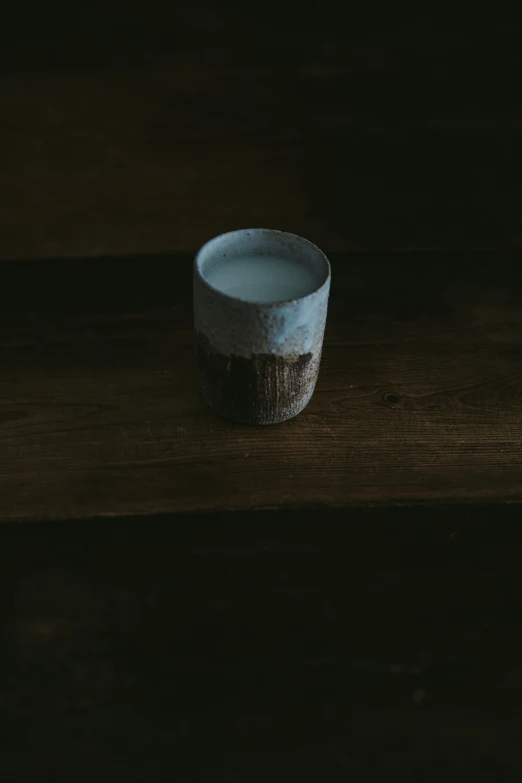 a small cup sits on top of the table