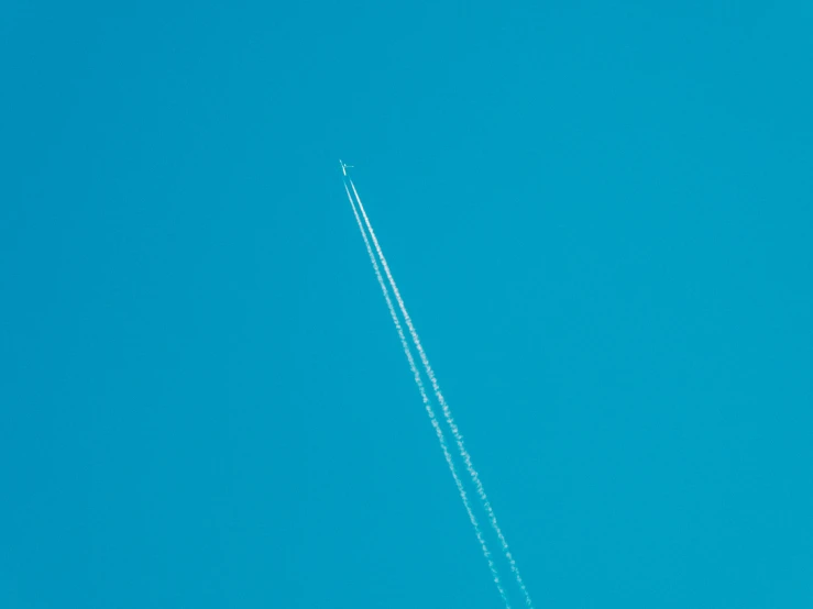airplane flying on a clear sky above a large city