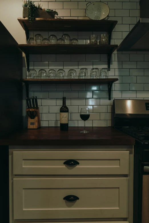 a kitchen with a counter and shelves with dishes