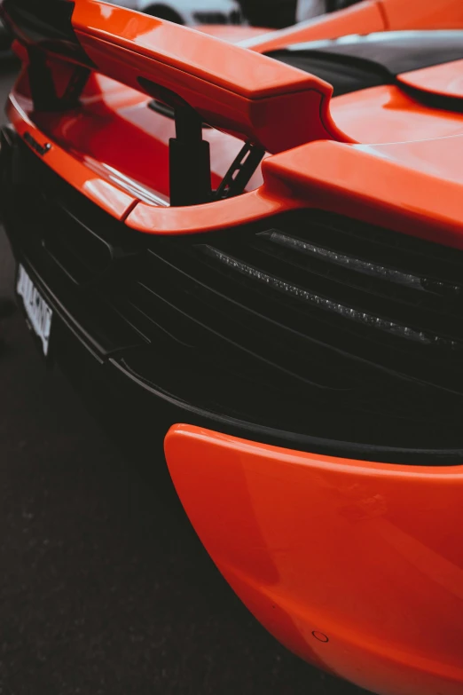 the front bumper plate on the bright orange sports car