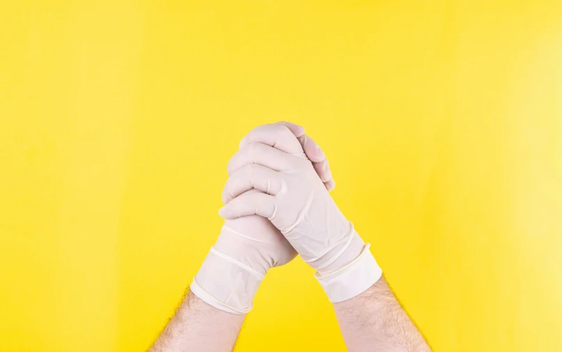 a person wearing white gloves standing with their arms around each other