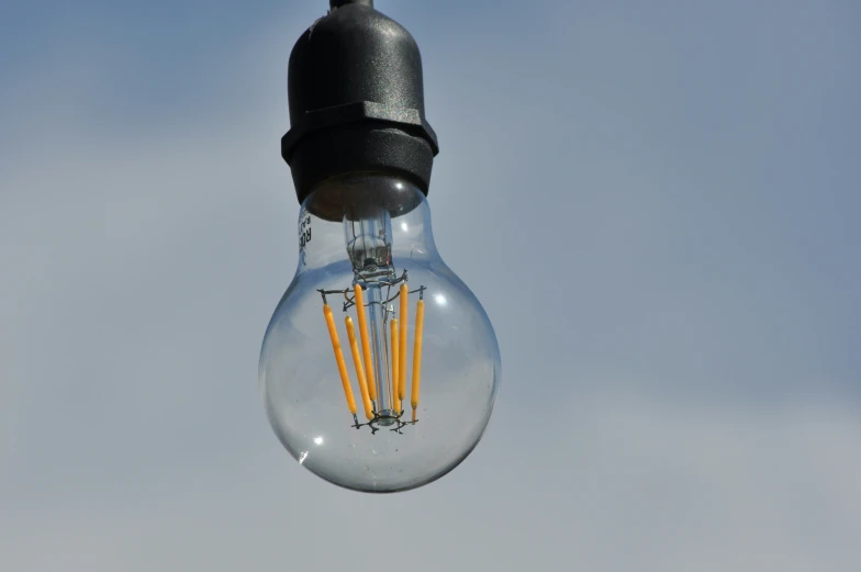 light bulb with four yellow wires attached to it