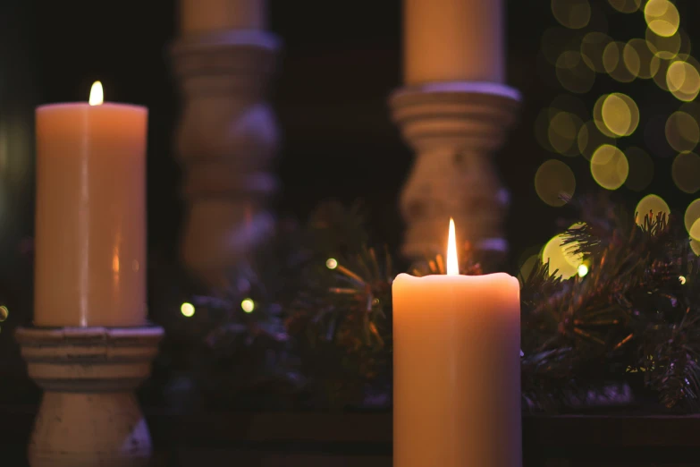 a lit candle near the tree and decorations