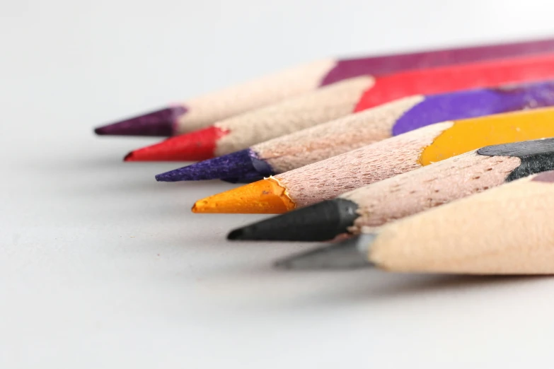 some colored pencils lined up against each other