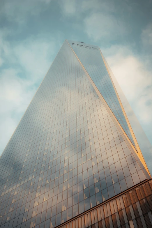 a very tall building sitting next to a big blue sky