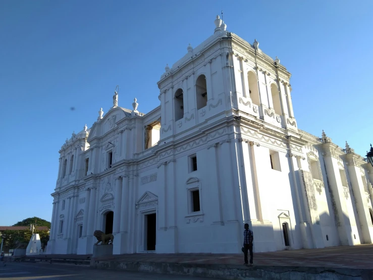 an old white building has many doors