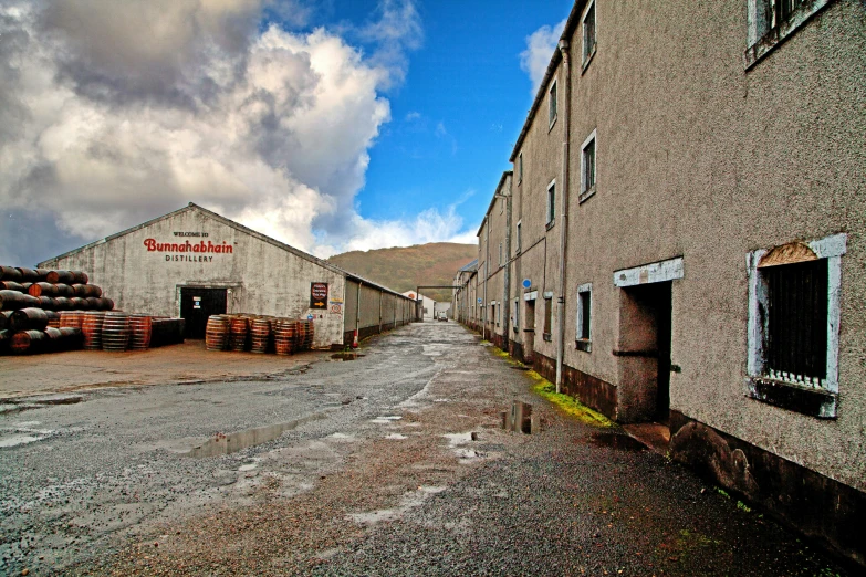 a long empty street near a factory