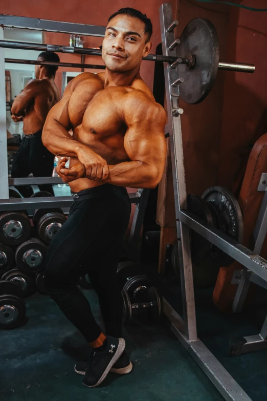 a male bodybuilding competitor standing in the gym