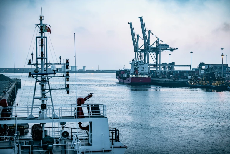 two tugboats, one pulling up a smaller boat