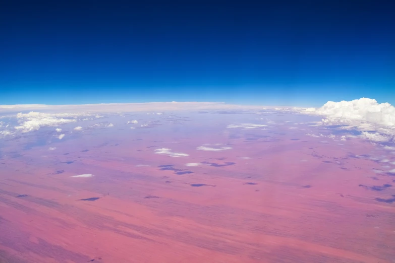 the aerial view of a plane that is flying in the sky