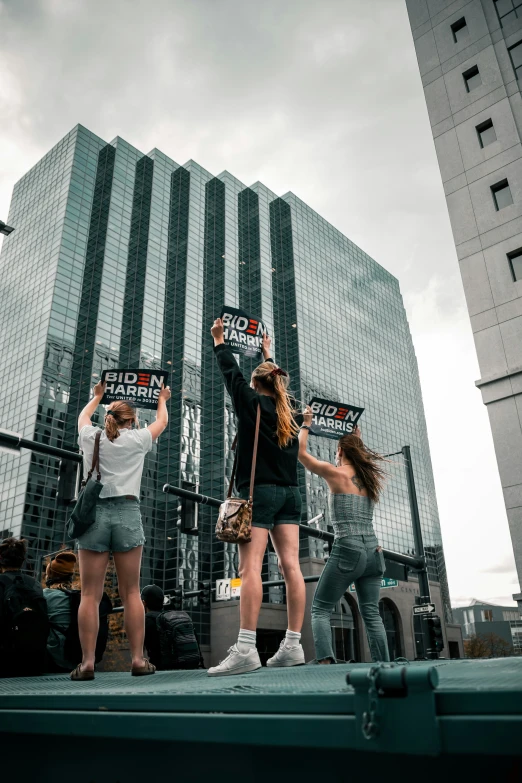 a group of young women standing in front of a large building