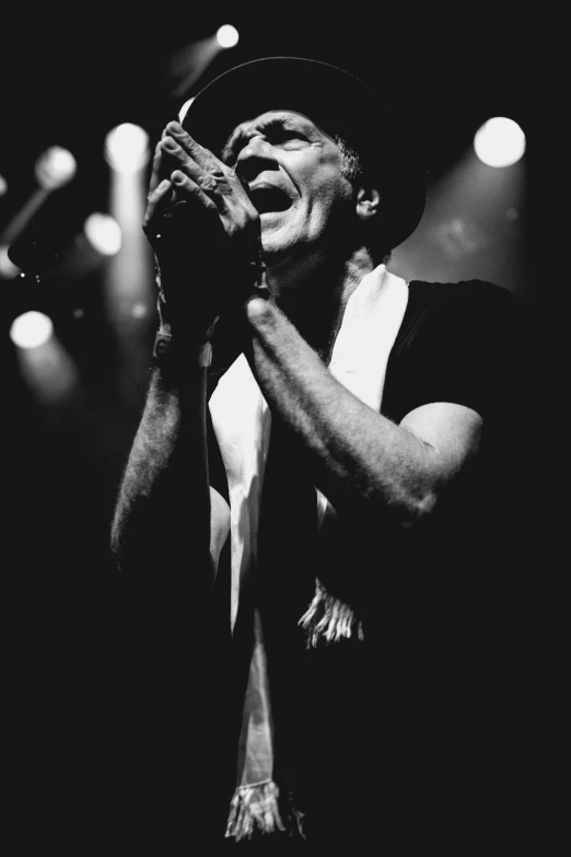 an image of a man singing into a microphone