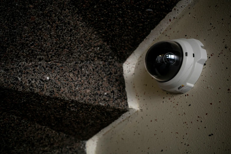 a white camera is sitting on a tiled floor