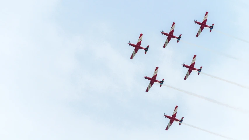 a number of planes flying in the sky