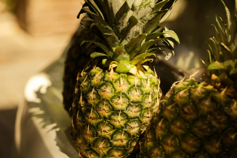 a white plate topped with three green pineapples