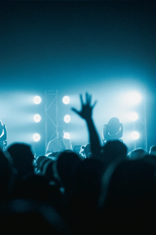 a band is performing at a concert as people in the stands look on