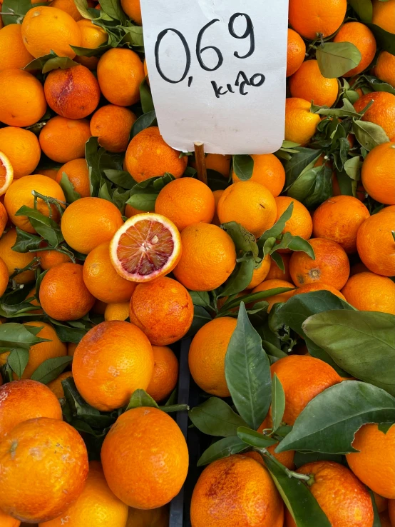 a display of a number of oranges at a fruit stand