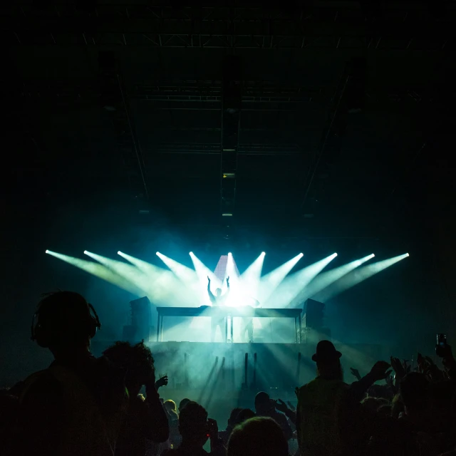 an audience is watching a person perform on stage