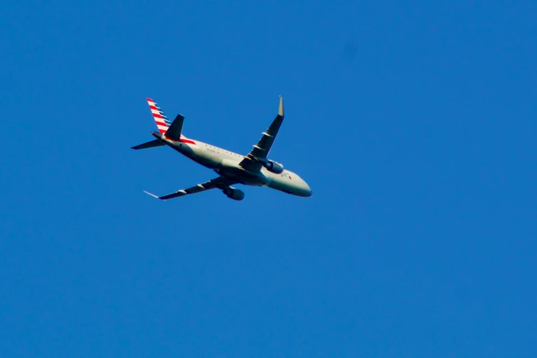 there is an airplane flying on a clear day