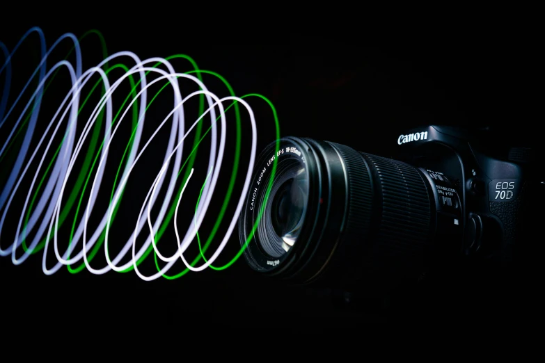 a camera with green and white lens sitting in front of some spiraly neon lights