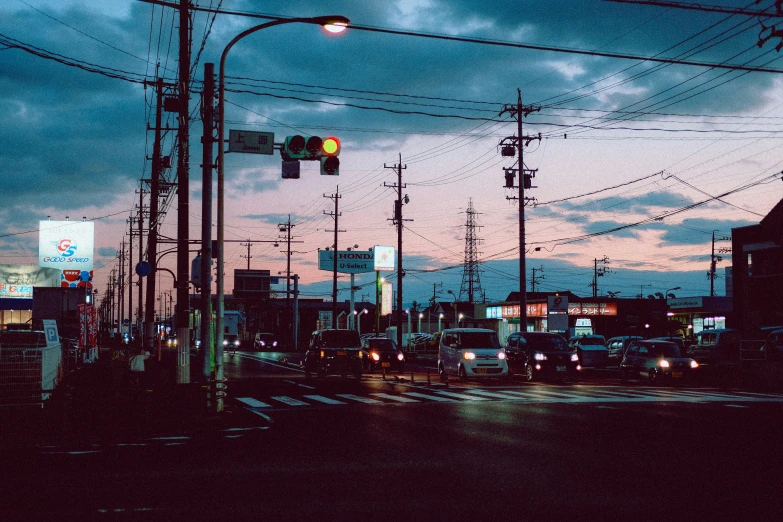 city traffic at night with dark sky in the background