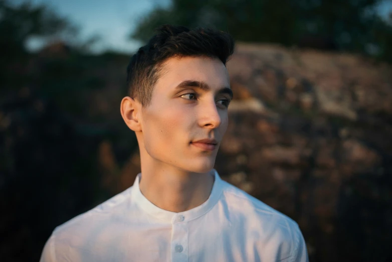 a close up view of a person in front of a mountain