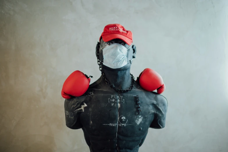 a mannequin has boxing gloves wrapped around his back