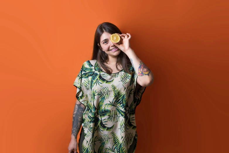 a woman poses with her yellow cupcake