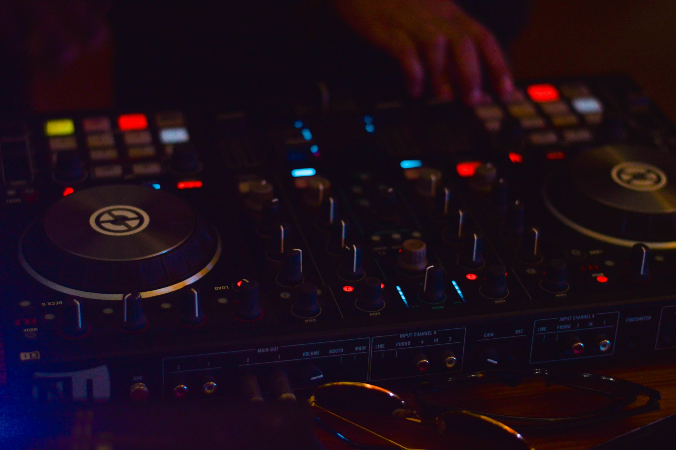 person mixing on a multi - colored dj's turn board