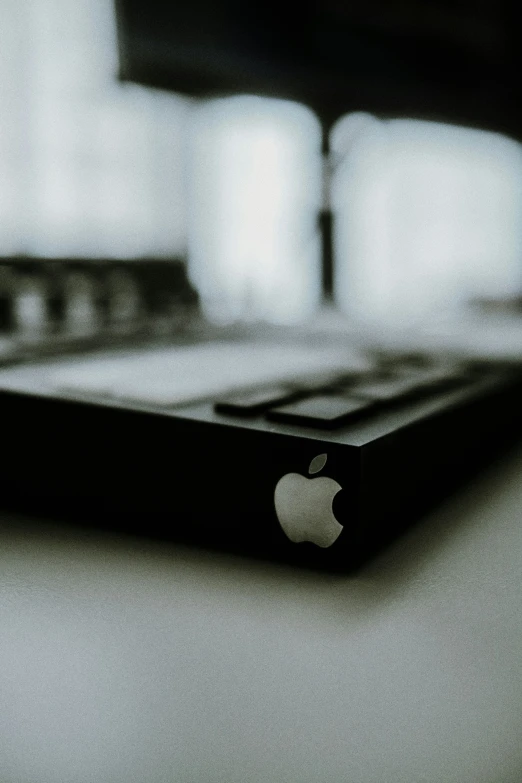 a close up of an apple power bank on a table