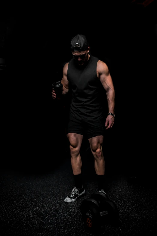 a man with muscles standing in the dark