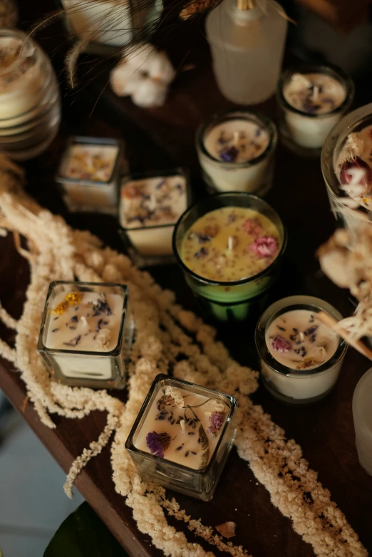 some small glass containers sitting on a wooden table