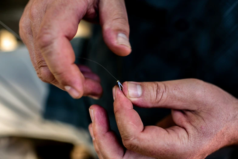 two men work on some sort of string