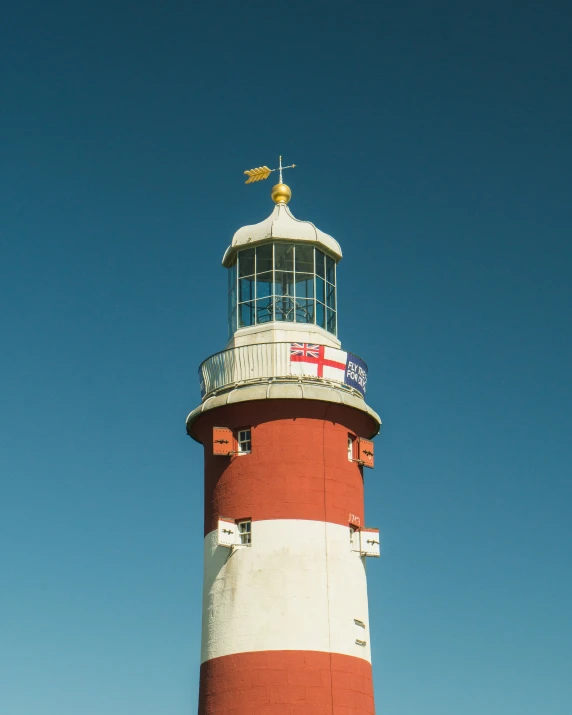 a light house that is sitting on a hill