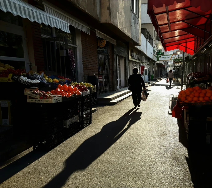 a person walking down a street with some produce