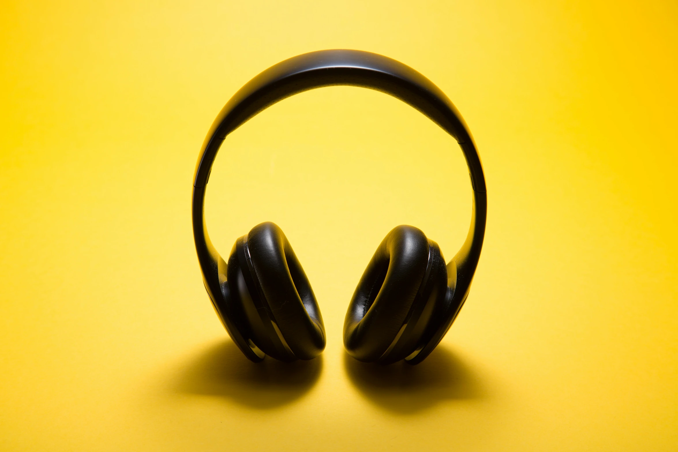 two headset on the floor with yellow background