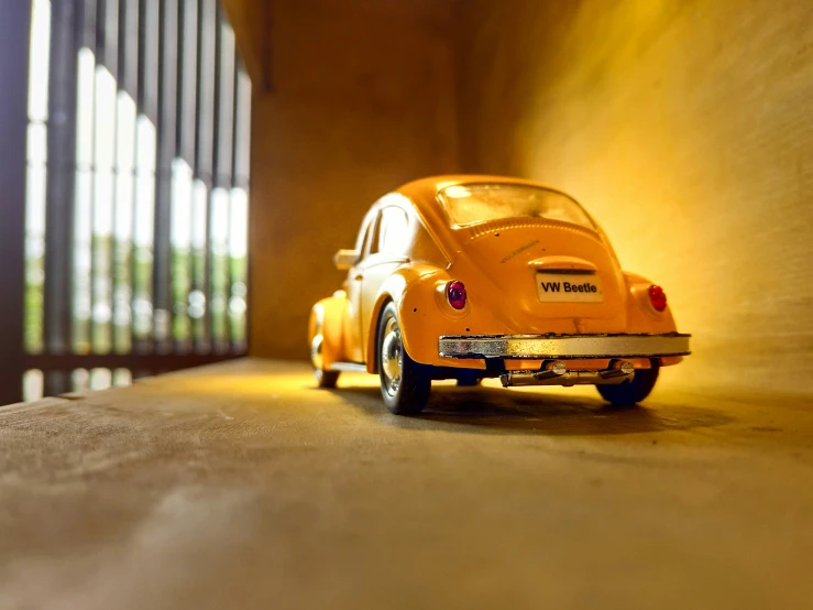 toy car, yellow and black sitting in corner with blinds on the wall