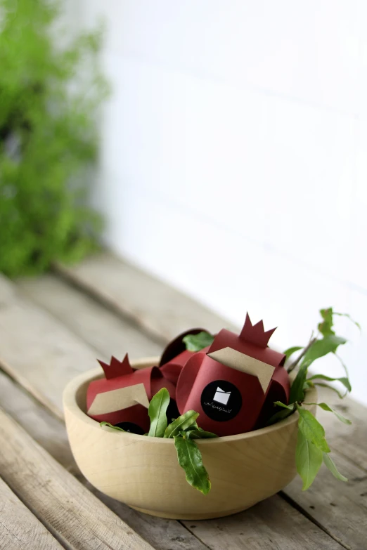 a bowl with three paper dragon sculptures in it