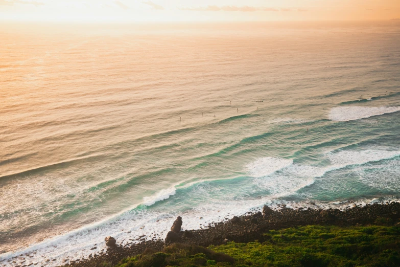 a long sandy beach near the shore with waves crashing