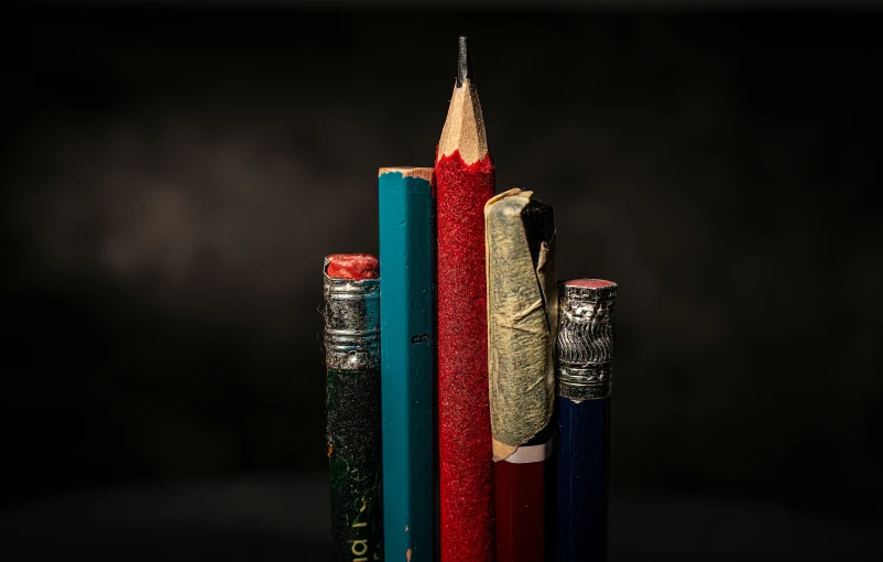 four pencils stacked on top of each other in different colors