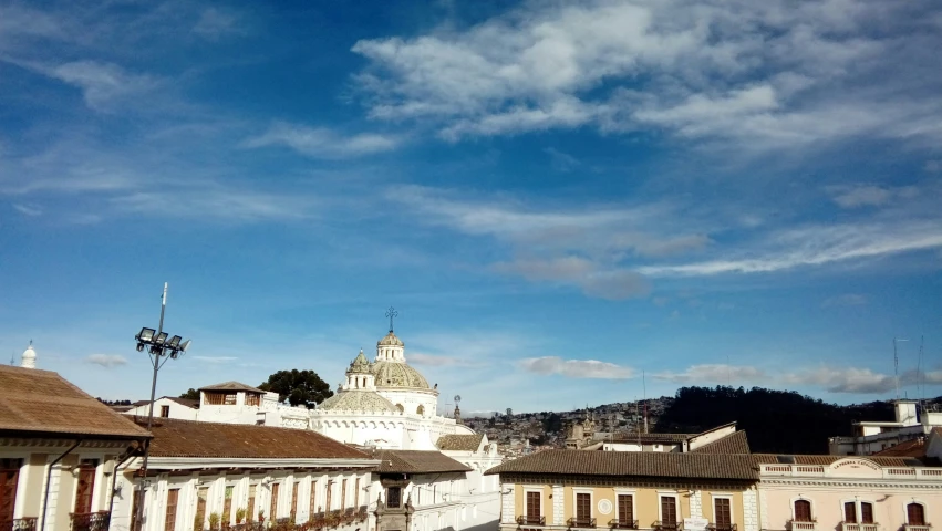 some buildings and a clock tower under a blue sky