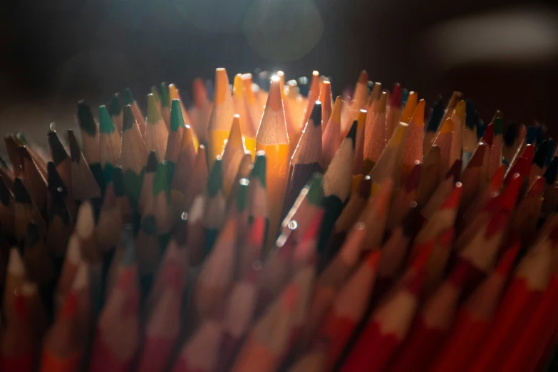 large group of colored pencils, including one with red, yellow and green colors