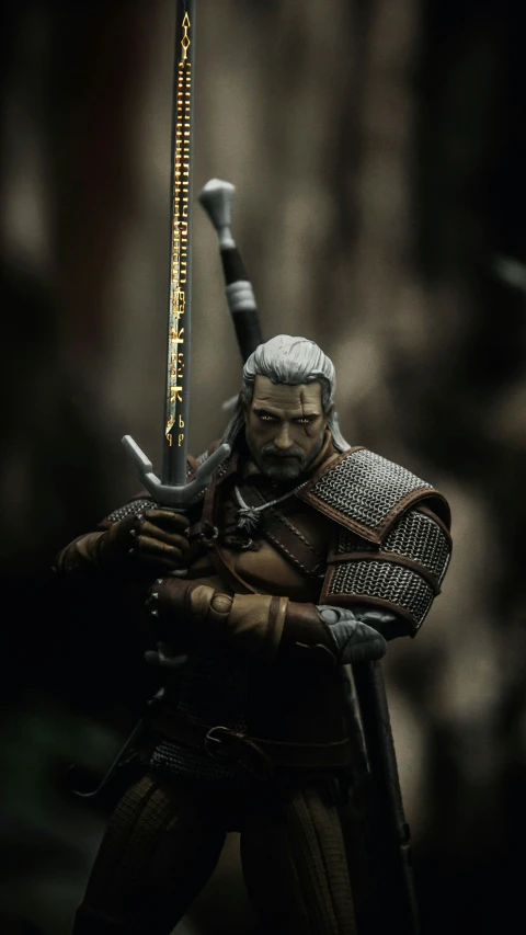 the action figure is wearing armor with a spear