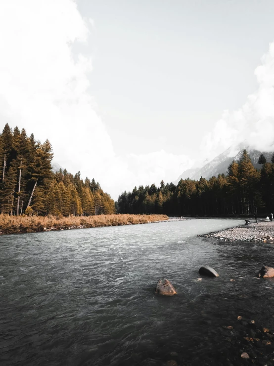 a very pretty river surrounded by some rocks