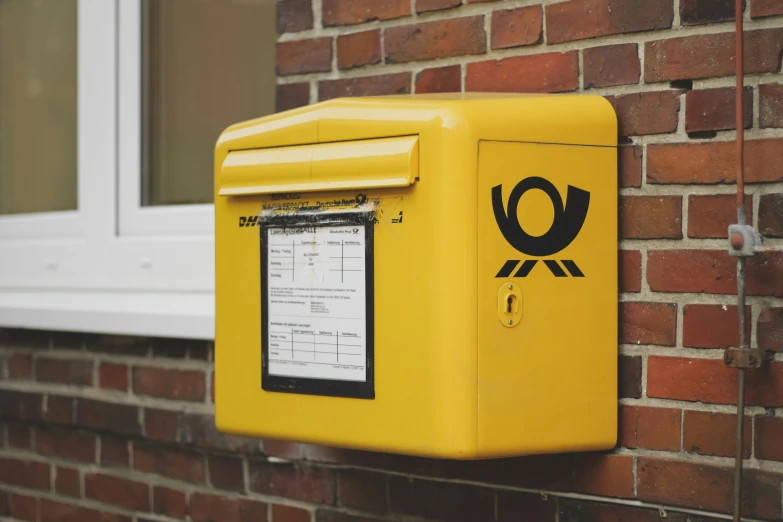 an emergency box mounted to the side of a brick wall