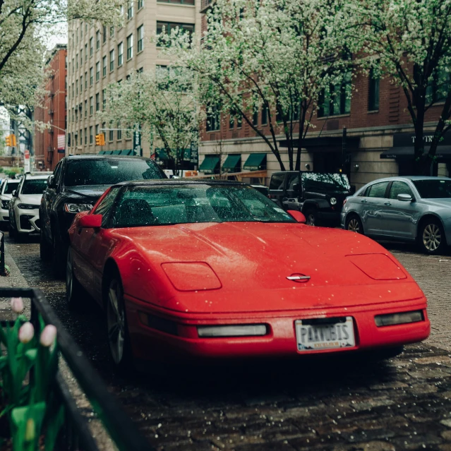 a red car is parked in the street